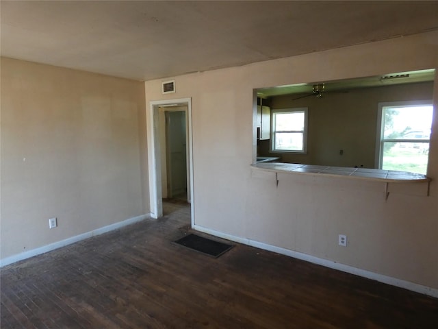 unfurnished room with dark hardwood / wood-style flooring