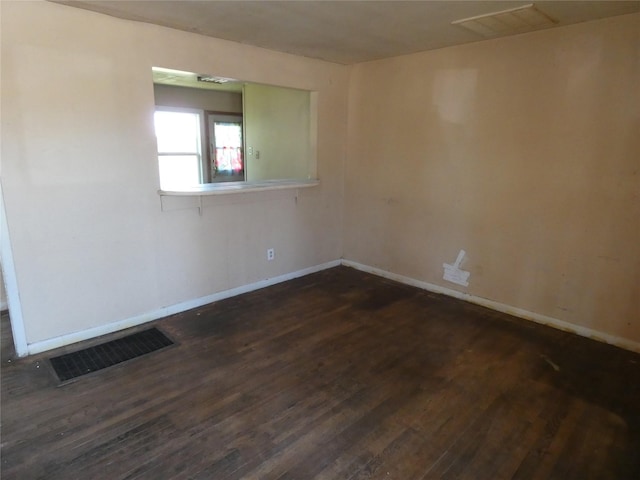 empty room featuring dark hardwood / wood-style flooring