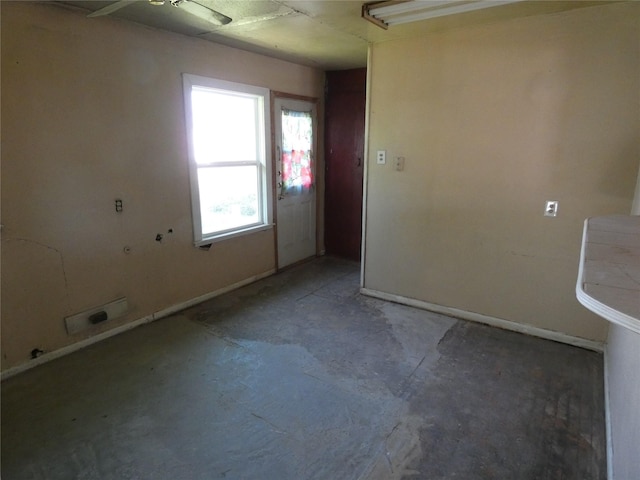 empty room with concrete flooring