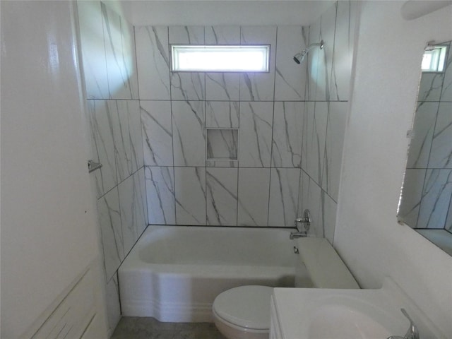 full bathroom with tiled shower / bath, sink, and toilet