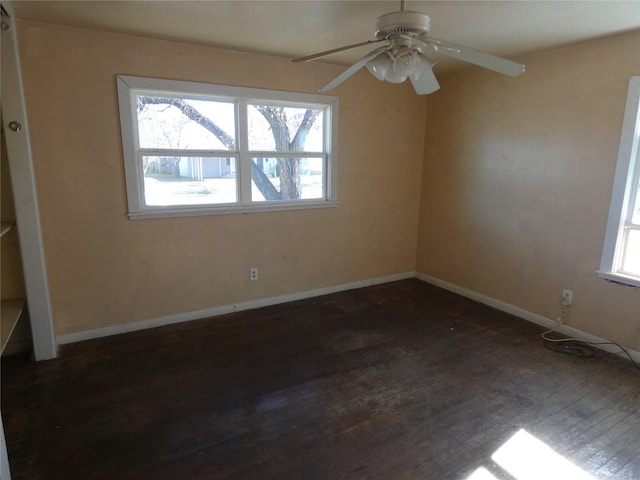 empty room with dark hardwood / wood-style floors and ceiling fan