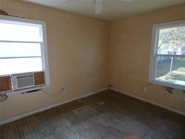 empty room with dark hardwood / wood-style floors, cooling unit, and ceiling fan