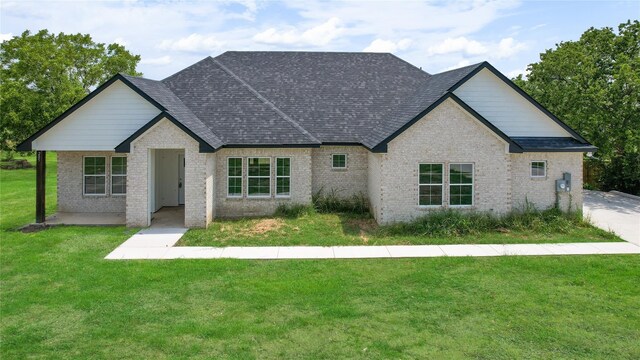 french country inspired facade with a front yard