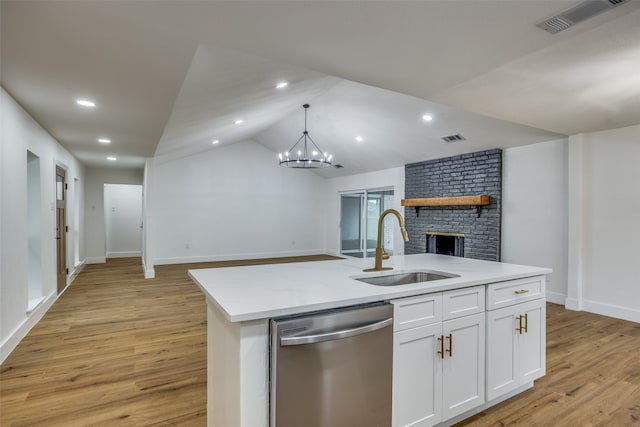 kitchen featuring stainless steel dishwasher, a kitchen island with sink, sink, light hardwood / wood-style flooring, and white cabinetry