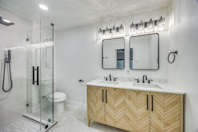 bathroom with vanity, toilet, and a shower with shower door