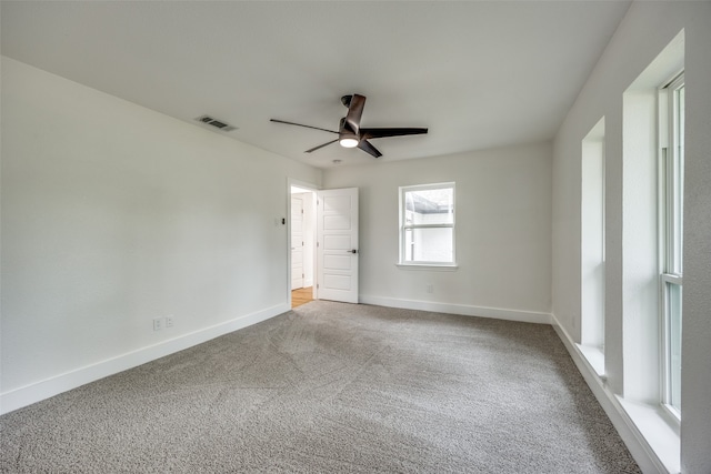 unfurnished room with ceiling fan and carpet floors