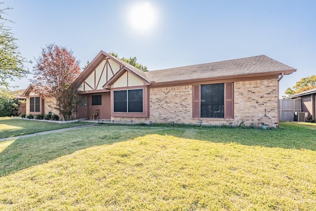 view of front of home featuring central AC unit and a front lawn