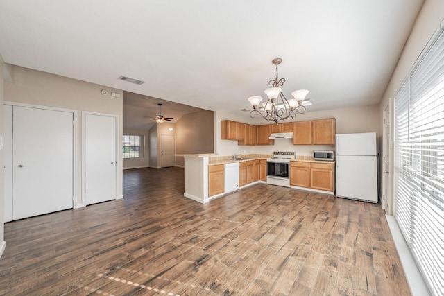 kitchen featuring pendant lighting, white appliances, kitchen peninsula, and dark wood-type flooring