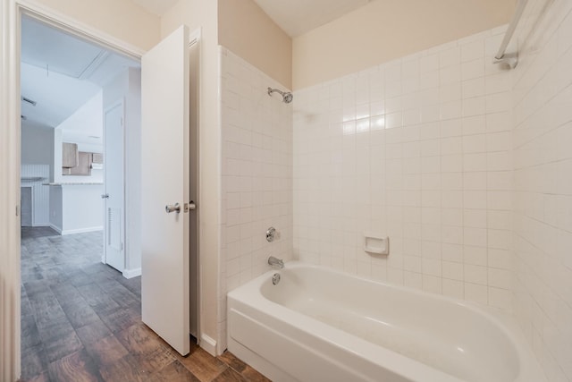 bathroom with tiled shower / bath combo and wood-type flooring