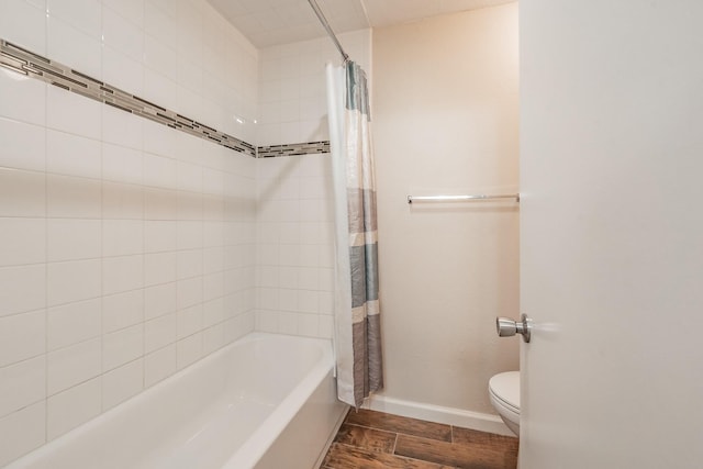 bathroom featuring toilet, shower / tub combo with curtain, and hardwood / wood-style flooring