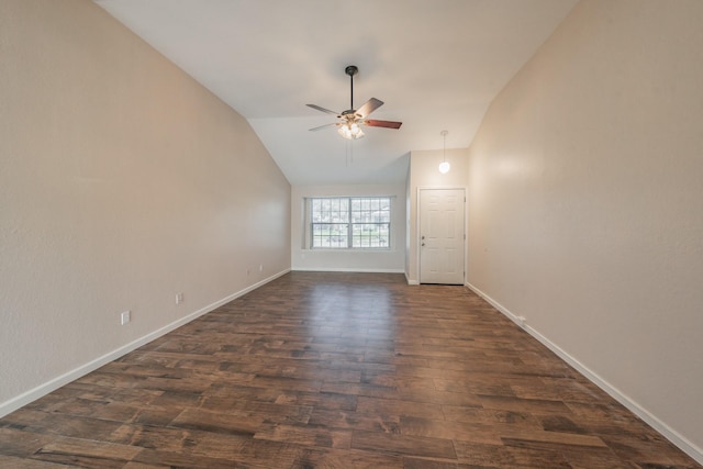 empty room with lofted ceiling, dark hardwood / wood-style floors, and ceiling fan