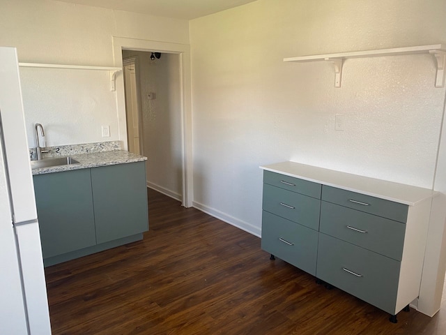 kitchen with sink and dark wood-type flooring