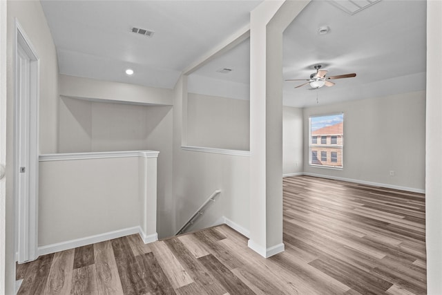 interior space featuring recessed lighting, visible vents, an upstairs landing, wood finished floors, and baseboards