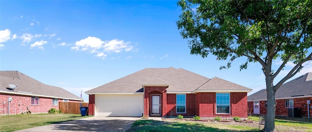 view of front of home with a garage and a front lawn