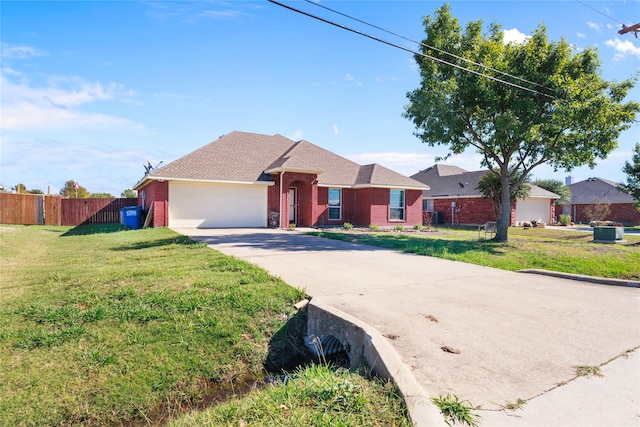 ranch-style house with a garage and a front lawn