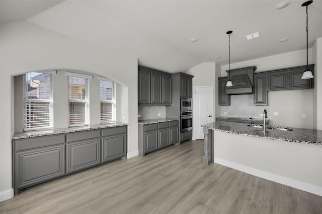 203 Half Moon Dr, Waxahachie, TX 75165 - kitchen with visible vents, lofted ceiling, custom range hood, a sink, and stainless steel appliances