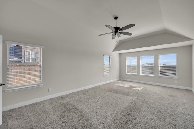 carpeted empty room with ceiling fan and vaulted ceiling