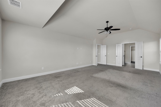 carpeted spare room with ceiling fan and vaulted ceiling