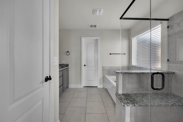 bathroom with tile patterned flooring, vanity, and shower with separate bathtub