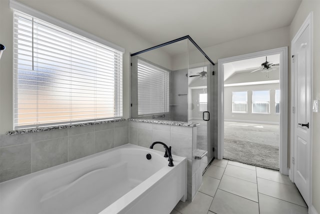 bathroom featuring tile patterned flooring, a healthy amount of sunlight, lofted ceiling, and separate shower and tub