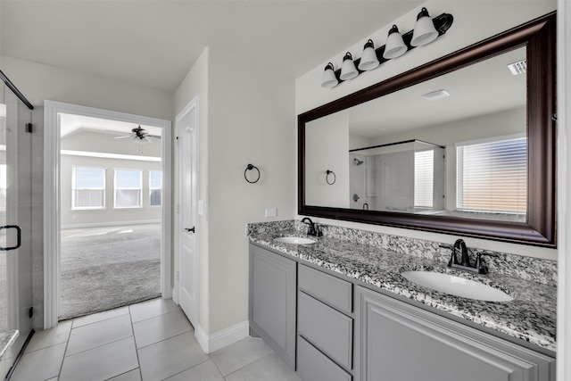 bathroom featuring tile patterned floors, ceiling fan, a shower with shower door, and vanity