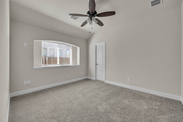 carpeted empty room featuring vaulted ceiling and ceiling fan