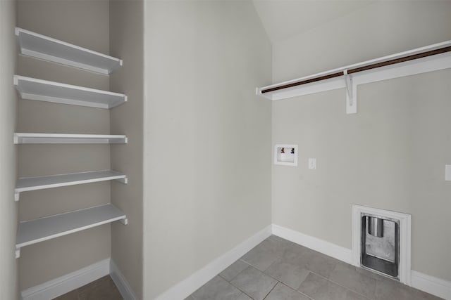 laundry room with washer hookup and light tile patterned floors