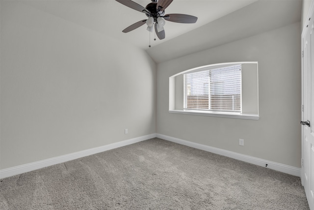 empty room with ceiling fan, carpet floors, and vaulted ceiling