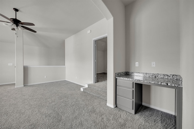 203 Half Moon Dr, Waxahachie, TX 75165 - unfurnished office featuring ceiling fan, light colored carpet, arched walkways, built in study area, and baseboards