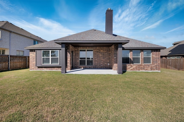 rear view of house with a yard and a patio area