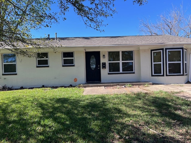 ranch-style house with a front lawn