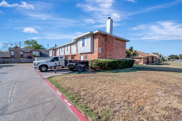 view of side of home with a yard