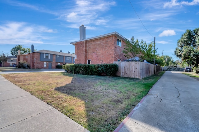 view of property exterior with a yard