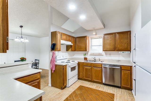 kitchen with light wood-type flooring, a textured ceiling, hanging light fixtures, sink, and white appliances