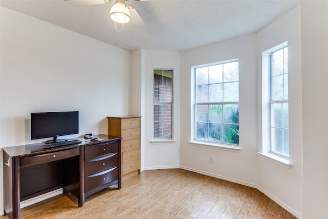 office with light hardwood / wood-style floors, a textured ceiling, and ceiling fan