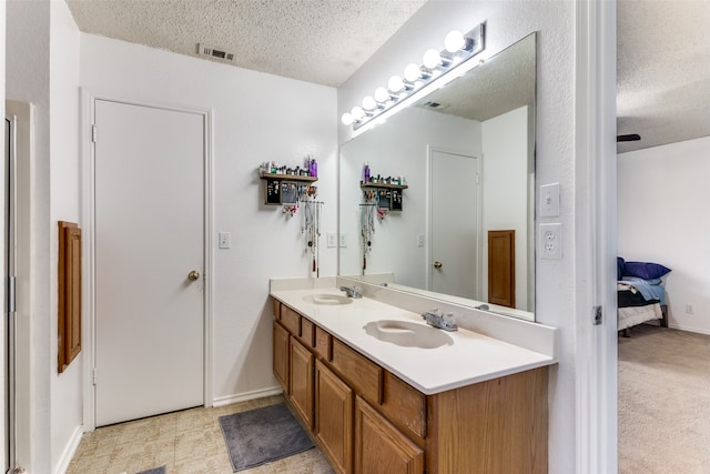 bathroom featuring vanity and a textured ceiling