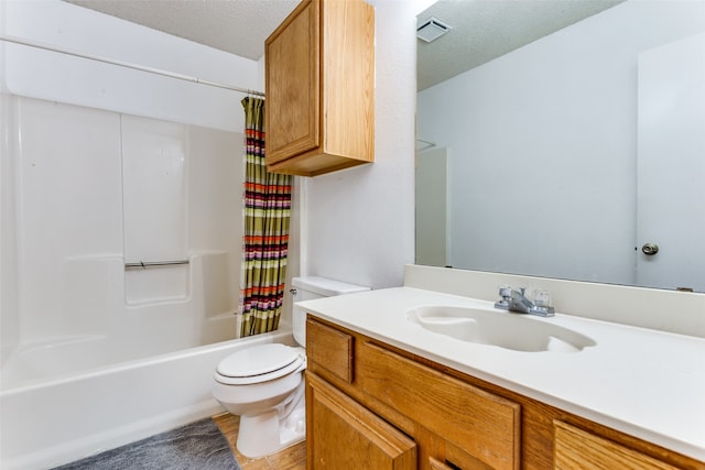 full bathroom with shower / bath combination with curtain, vanity, a textured ceiling, and toilet