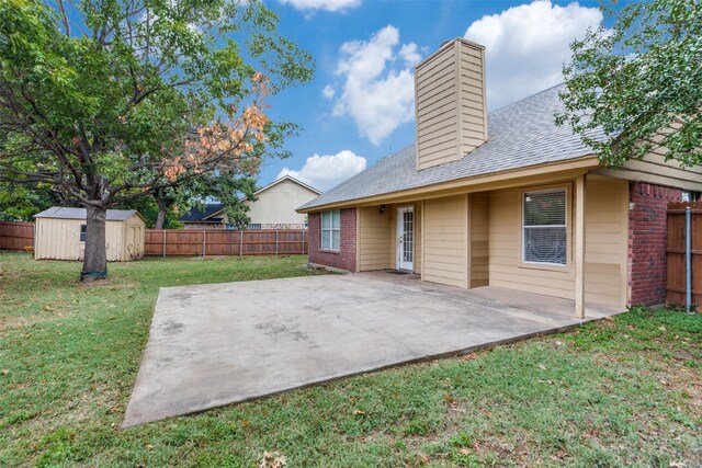 back of property featuring a patio area, a yard, and a storage shed