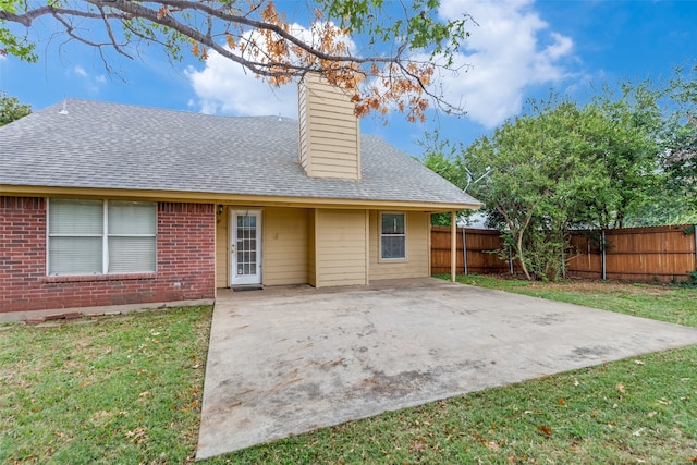 rear view of house featuring a yard and a patio area