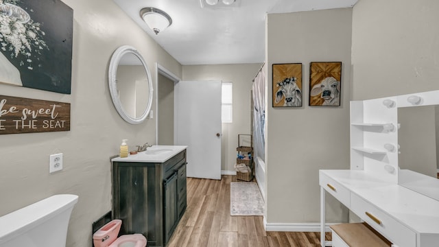 full bathroom featuring vanity, hardwood / wood-style flooring, toilet, and shower / tub combo