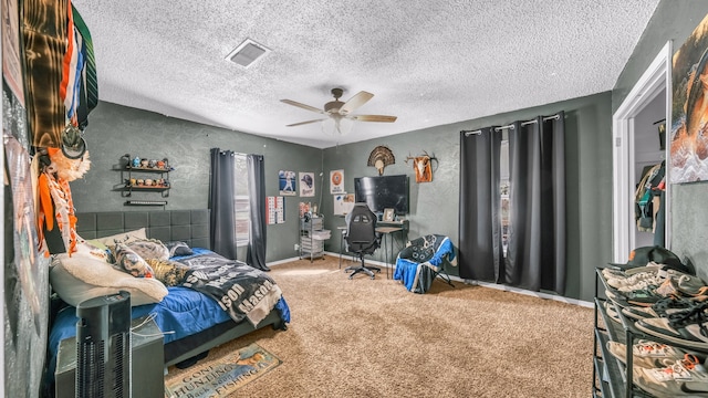 carpeted bedroom featuring a textured ceiling and ceiling fan