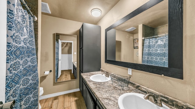 bathroom featuring vanity, hardwood / wood-style flooring, and toilet