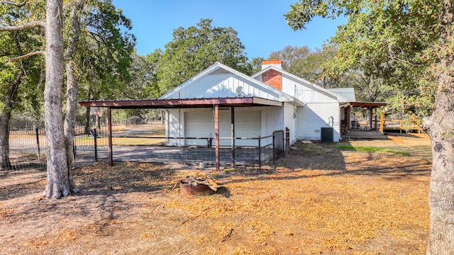 view of side of home featuring central AC unit and a garage