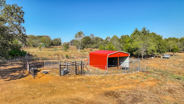 view of yard featuring an outdoor structure and a rural view