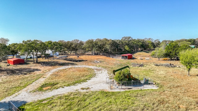 view of yard featuring a rural view and an outbuilding