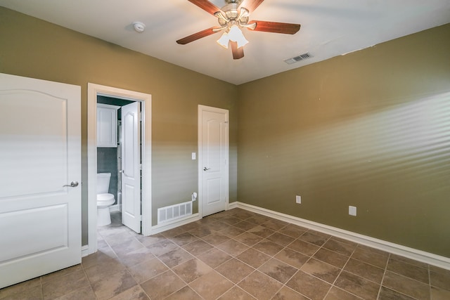 unfurnished bedroom featuring tile patterned flooring, ensuite bath, and ceiling fan