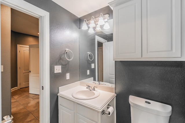 bathroom featuring toilet, vanity, and tile patterned floors