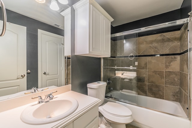 full bathroom with toilet, combined bath / shower with glass door, and vanity