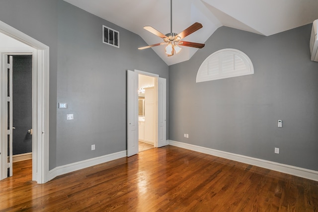 unfurnished bedroom featuring ensuite bathroom, high vaulted ceiling, wood-type flooring, and ceiling fan