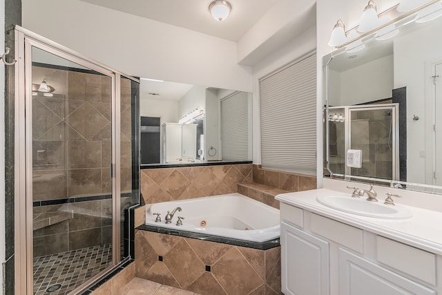 bathroom featuring tile patterned flooring, shower with separate bathtub, and vanity